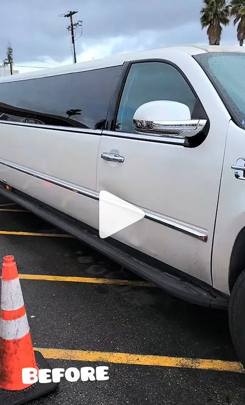 White limousine with visible dent on the door before professional paintless dent repair in Sacramento