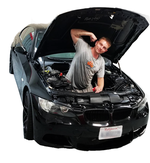 Alex from Glass Reflections flexing inside his black BMW performance car with the hood open after removing the engine — Sacramento mobile dent repair expert and PDR specialist